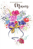 This illustrated Mother's Day card features an exuberant watercolour bouquet that seems to burst upwards from a delicate vase, its colours blooming like springtime across a Kensington terrace. Large, loosely defined flowers in shades of raspberry pink, fuchsia and soft rose form the heart of the design, with darker indigo strokes providing depth and gently curling around the petals to suggest movement. Cooler blue and lilac blossoms mingle among them, their softer tones balancing the intensity and evoking the quiet calm of early morning walks through Kensington Gardens when the beds are just beginning to flower. Thin lines and small accents of metallic gold highlight the edges of petals and leaves, shimmering subtly as if reflecting the glow of shopfront lights along Kensington High Street at dusk. The vase itself is rendered with light washes of colour, its rounded shape only partly defined, and finished with a painted golden bow that hints at the tactile feel of real ribbon tied around a hand-tied bouquet. Around the main cluster, scattered paint splatters, tiny hearts and dots drift across the bright white card, adding a playful, celebratory spirit that feels like children's laughter echoing up from a nearby square. The overall effect is airy and affectionate, like a bouquet captured in motion rather than posed. It conveys the emotion behind Mother's Day gifting in Kensington-the wish to wrap love, gratitude and shared memories into something beautiful and thoughtful, whether it's delivered to a townhouse near Holland Park or a cosy flat just off Kensington High Street.